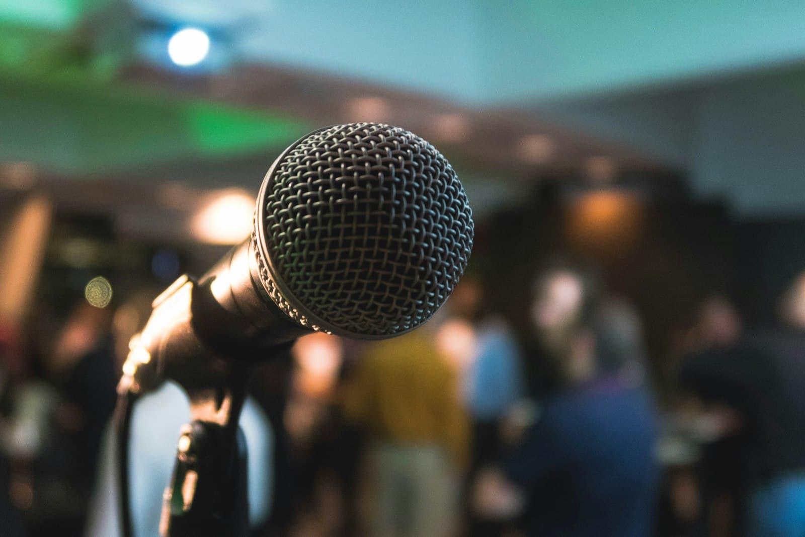A microphone in front of a seated audience